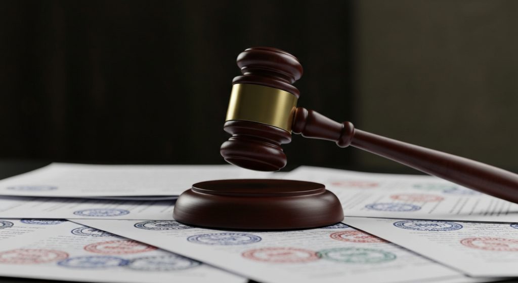 Gavel striking documents, symbolizing denial of a real estate financing.