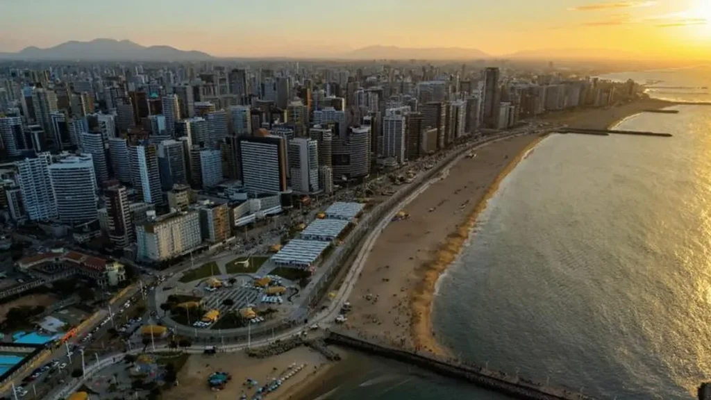 Rua movimentada em Fortaleza com edifícios residenciais e comerciais modernos.